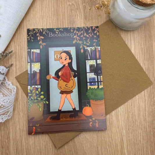 Postkarte Buchladen im Herbst - Bücherwurm Illustration A6 | Cozy Herbstkunst mit Leseglück